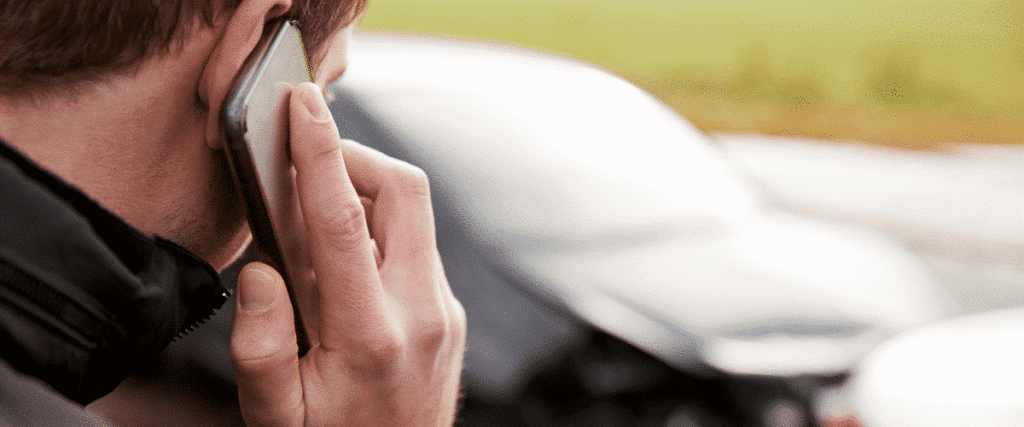 man makes phone call for minor car accident
