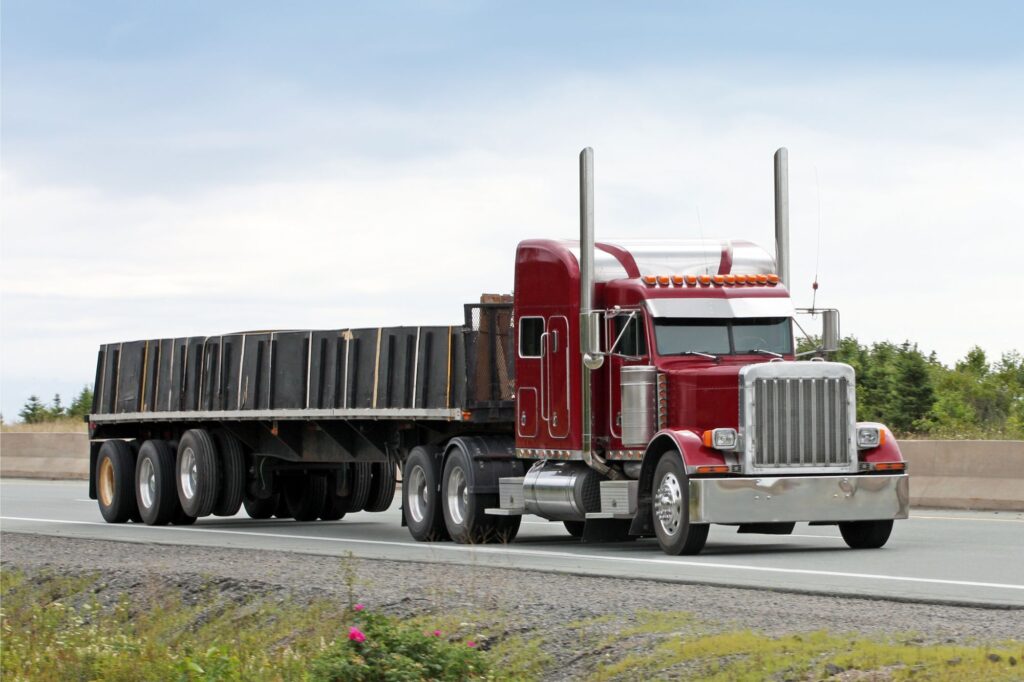 flatbed truck driving on road - flatbed truck accident lawyer in west virginia
